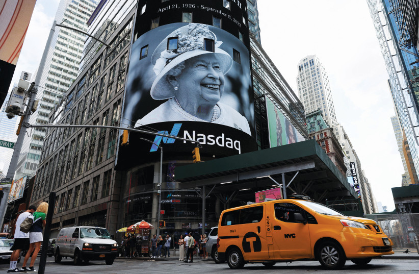  A TRIBUTE to Queen Elizabeth appears on the screen of the Nasdaq MarketSite billboard in Times Square, New York City, upon the news of the British monarch’s death on September 8. (photo credit: Andrew Kelly/Reuters)