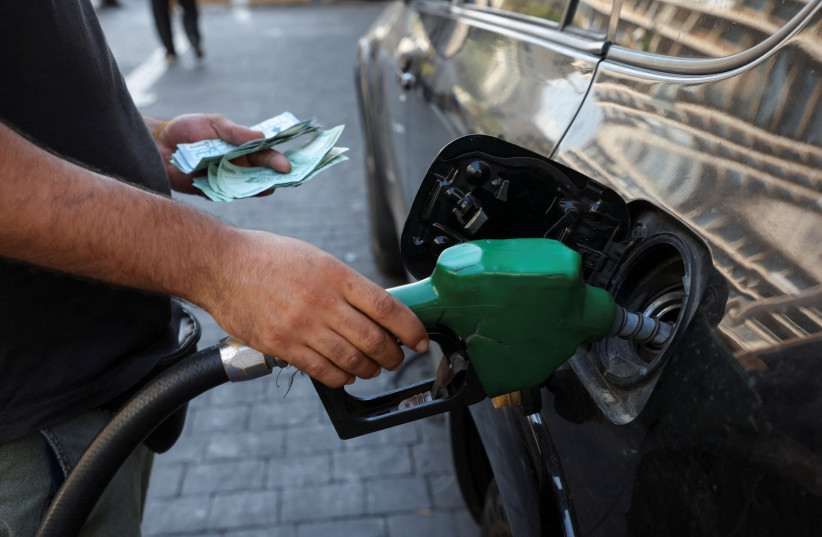A worker fills up a car with fuel at a gas station in Beirut, Lebanon, September 12, 2022. (photo credit: REUTERS/MOHAMED AZAKIR)
