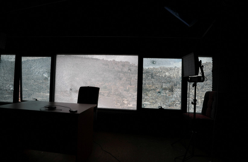  A view of damaged windows of Palestine TV's studio following clashes between Palestinian security forces and gunmen over the arrest of two Palestinian militants, in Nablus in the West Bank September 20, 2022. (credit: REUTERS/MOHAMAD TOROKMAN)
