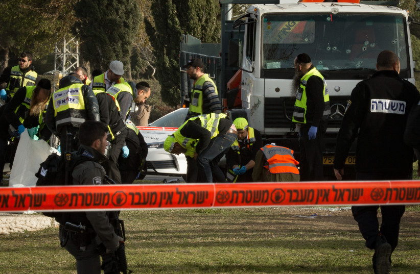 The scene of a where a truck rammed in a group of Israeli soldiers, killing four in a suspected vehicle-ramming attack, in the Armon haNatsiv neighborhood of jerusalem.  (photo credit: SEBI BERENS/FLASH90)