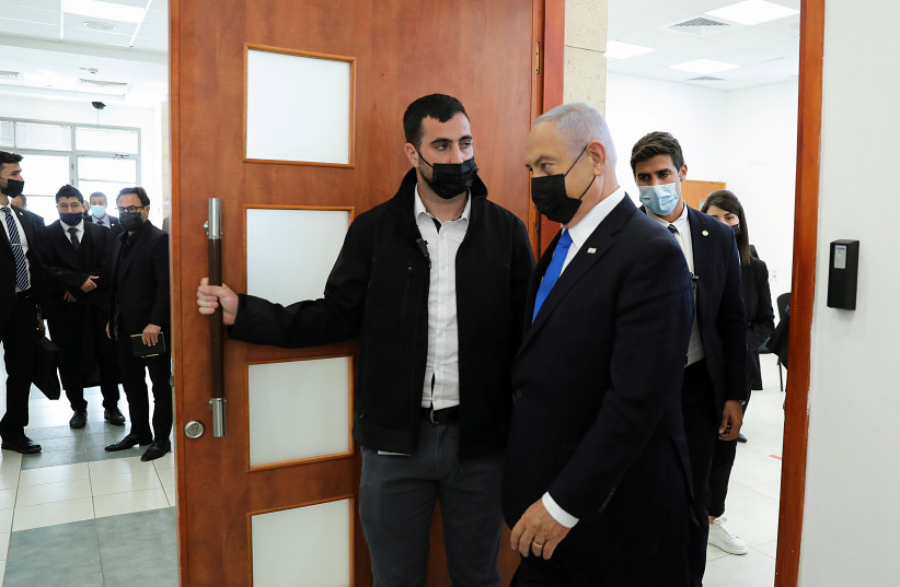  Benjamin Netanyahu, wearing a face mask, leaves the courtroom during a hearing in the Jerusalem District Court last year. (credit: Abir Sultan/Pool via REUTERS)