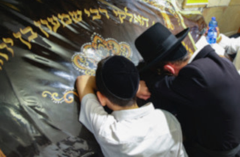  PRAYING AT Rabbi Simeon Bar Yochai’s tomb in Meron. A 1st-century tannaitic sage in ancient Israel and an eminent disciple of Rabbi Akiva, Rashbi is attributed by many with the authorship of the Zohar, chief work of the Kabbalah (photo credit: David Cohen/Flash90)
