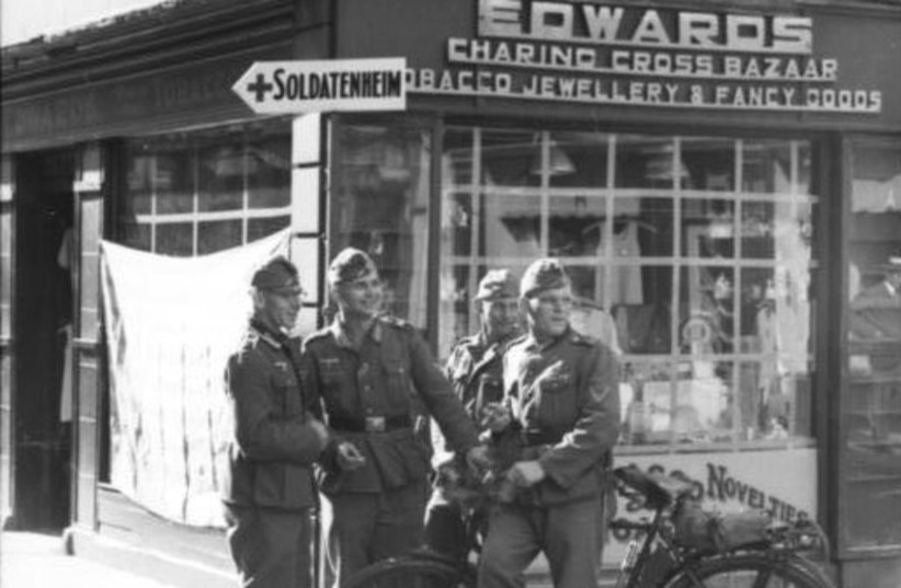  GERMAN SOLDIERS on King Street, St. Helier, at Charing Cross (now site of La Croix de la Reine monument, erected to mark the Queen’s Silver Jubilee in 1977) during the occupation of Jersey, 1940s. (credit: Wikimedia Commons)