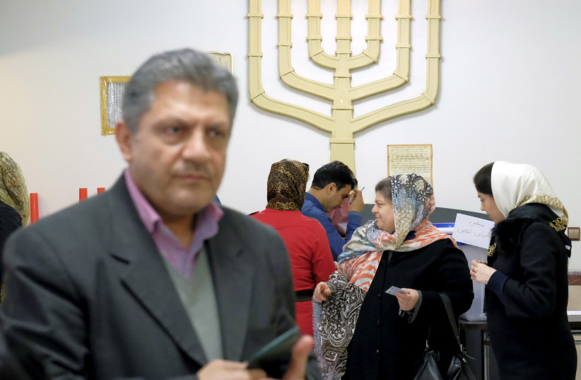  Iranian Jews wait to cast their ballots at a synagogue, used as a polling station, during elections for the parliament and Assembly of Experts, which has the power to appoint and dismiss the supreme leader, in Tehran February 26, 2016. (credit: REUTERS/RAHEB HOMAVANDI/TIMA)