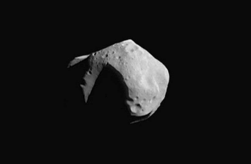  This image mosaic of asteroid 253 Mathilde releaseed by NASA 30 June is constructed from four images acquired by the NEAR spacecraft on 27 June. The images were taken from a distance of 1,500 miles (2,400 kilometers) with sunlight coming from the upper right. (photo credit: NASA/AFP via Getty Images)