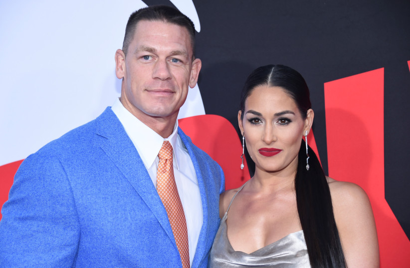  Cast member John Cena (L) and Nikki Bella attend the premiere of "Blockers" in Los Angeles, California, U.S. April 3, 2018.  (photo credit: REUTERS/PHIL MCCARTEN)