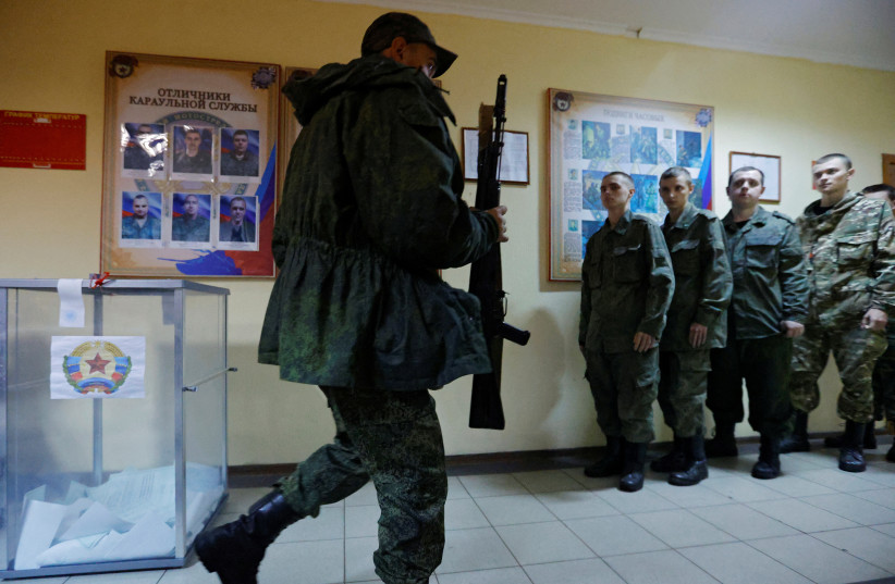  Service members of the self-proclaimed Luhansk People's Republic vote during a referendum in Luhansk (photo credit: REUTERS)