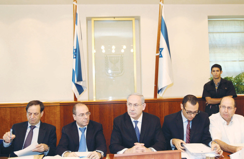  THE WRITER (left) attends a cabinet meeting under then-prime minister Benjamin Netanyahu, in Jerusalem, 2012. (photo credit: MIRIAM ALSTER/FLASH90)