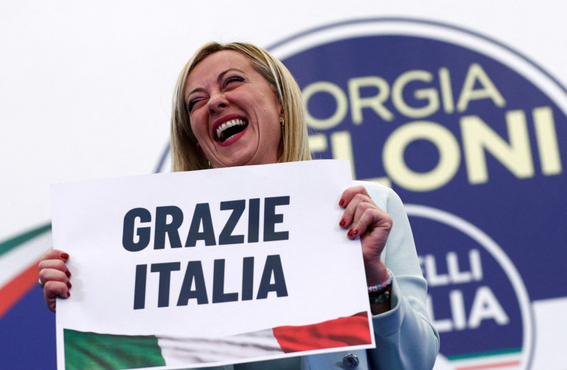  Leader of Brothers of Italy Giorgia Meloni holds a sign at the party's election night headquarters, in Rome, Italy September 26, 2022. (credit: REUTERS/GUGLIELMO MANGIAPANE)