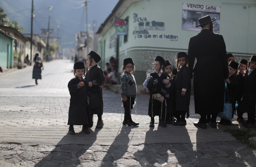  Members of a Jewish community stand on a street in the village of San Juan La Laguna August 24, 2014 (photo credit: JORGE DAN LOPEZ/REUTERS)