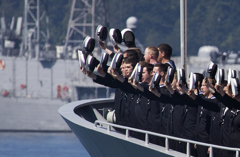  Sailors aboard the New Zealand ship HMNZS Te Kaha raise their hats to Canadian Governor General Michaelle Jean as she sails by during a Fleet Review in Victoria, British Columbia June 12, 2010. (photo credit: REUTERS/Andy Clark)
