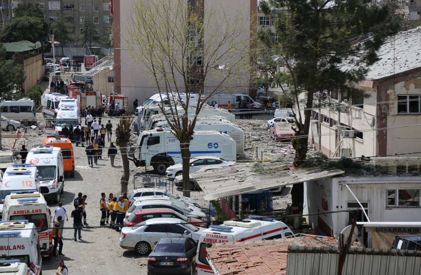  Ambulances are parked near a police compound after an explosion in the southeastern city of Diyarbakir, Turkey, April 11, 2017. (photo credit: Sertac Kayar/Reuters)