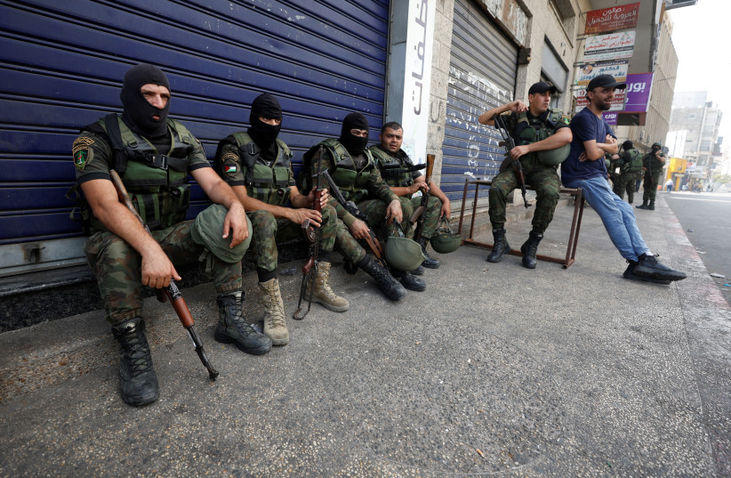  Members of Palestinian security forces rest following clashes with gunmen over the arrest of two Palestinian militants, in Nablus in the Israeli-occupied West Bank September 20, 2022 (credit: REUTERS/MOHAMAD TOROKMAN)