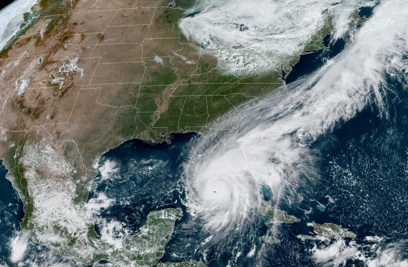  Hurricane Ian makes its way to Florida's west coast after passing Cuba in a composite image from the National Oceanic and Atmospheric Administration (NOAA) GOES-East weather satellite September 27, 2022.  (photo credit: NOAA/HANDOUT VIA REUTERS)