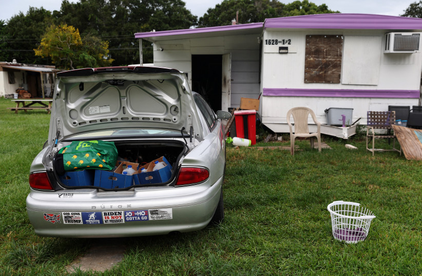  A car, filled up with water and supplies, sits outside a boarded-up trailer home, as Hurricane Ian spun toward the state carrying high winds, torrential rains and a powerful storm surge, in Clearwater, Florida, US, September 27, 2022. (credit: SHANNON STAPLETON/ REUTERS)