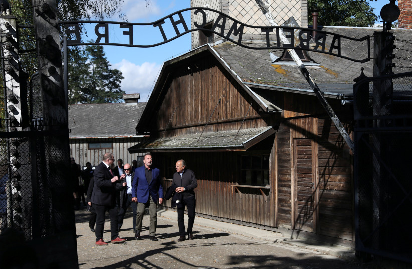 Actor and former California Governor Arnold Schwarzenegger visits former Nazi German concentration camp Auschwitz-Birkenau, near Oswiecim, Poland, September 28, 2022. (photo credit: JAKUB PORZYCKI/AGENCJA GAZETA VIA REUTERS)