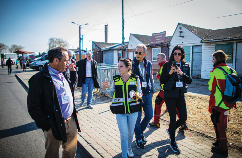  MARK WILF listens to first responders during a visit to the Ukraine/Poland border.  (photo credit: Eyal Warsavsky/Jewish Federations of North America)