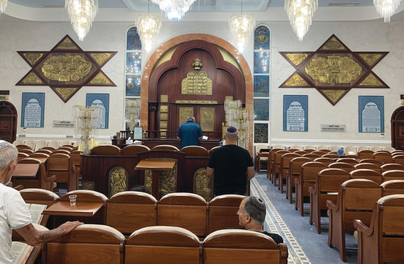  THE SPLENDID interior of the Moroccan Yitzhak Avinu Synagogue, with its framed ark and motifs of Jerusalem then and now. (credit: JACOB SOLOMON)