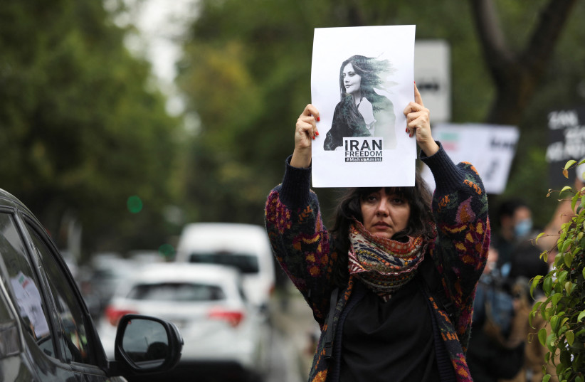  A woman holds up a sign during a protest against the Islamic regime of Iran and the death of Mahsa Amini, outside the Iranian embassy in Mexico City, Mexico, September 27, 2022. (credit: REUTERS/Paola Garcia)