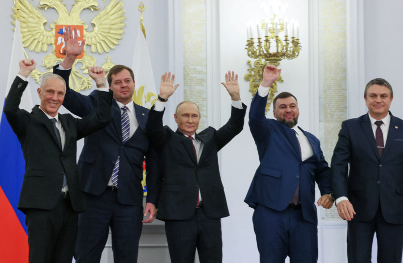 Russian President Vladimir Putin and Denis Pushilin, Leonid Pasechnik, Vladimir Saldo, Yevgeny Balitsky, who are the Russian-installed leaders in Ukraine's Donetsk, Luhansk, Kherson and Zaporizhzhia regions, attend a ceremony to declare the annexation of the Russian-controlled territories (photo credit: REUTERS)