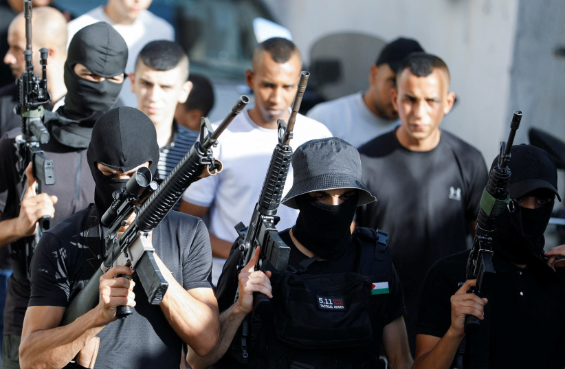  Armed men attend the funeral of Abdul Rahman Khazem, a Palestinian gunman and another man Muhammad Abu Naasa, who were killed by Israeli forces in a raid, in Jenin in the West Bank, September 28, 2022. (credit: REUTERS/RANEEN SAWAFTA)