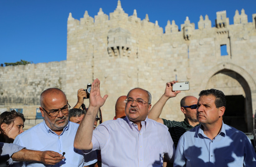  Arab members of the Israeli parliament Osama Saadi, Ahmad Tibi and Ayman Odeh stand together as Tibi speaks to the media, amid tension ahead of a flag-waving procession by far-right Israeli groups at Damascus Gate, just outside Jerusalem's Old City, June 15, 2021 (credit: REUTERS/AMMAR AWAD)