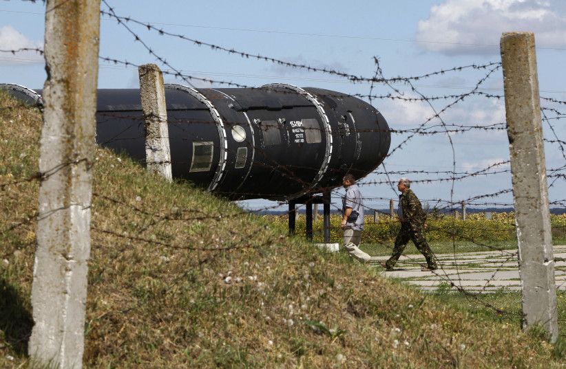  Visitors look at a Soviet-era SS-18 SATAN intercontinental ballistic missile at the Strategic Missile Forces museum near Pervomaysk, some 300 km (186 miles) south of Kyiv, August 22, 2011 (credit: REUTERS/GLEB GARANICH)