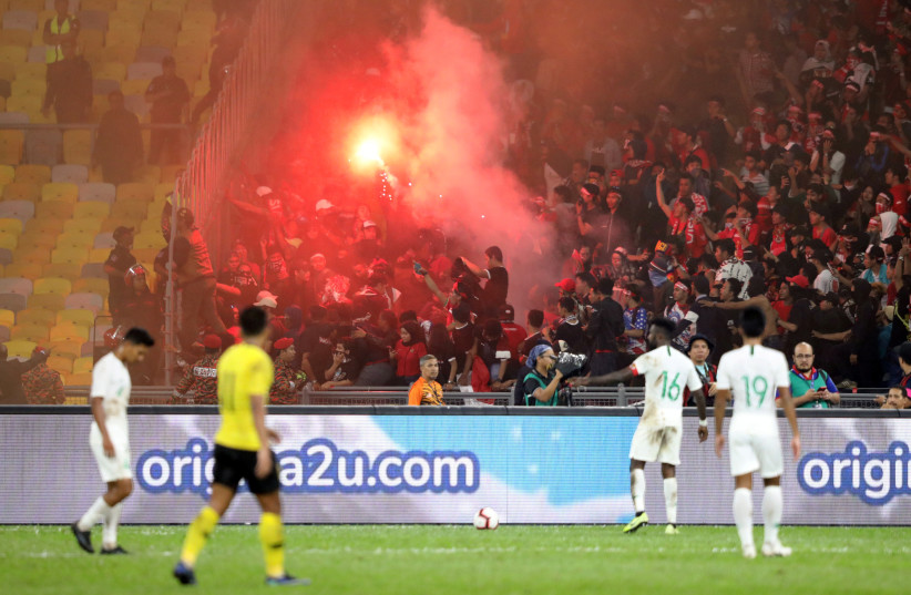 Malaysia v Indonesia - World Cup 2022 Qualifier, Second Round Group G and Asian Cup 2023 Qualifier Preliminary Round 2 Group G - Bukit Jalil National Stadium, Kuala Lumpur, Malaysia - November 19, 2019 General view as fans light a flare in the stands. (credit: REUTERS/LIM HUEY TENG)