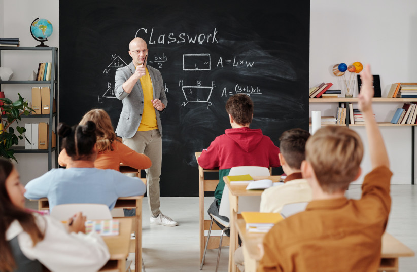Students and teacher in classroom (illustrative). (credit: PEXELS)
