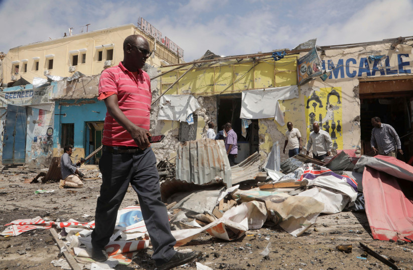  Residents look at the scene of an al Qaeda-linked al Shabaab group militant attack, in Mogadishu, Somalia August 21, 2022. (credit: REUTERS/FEISAL OMAR)