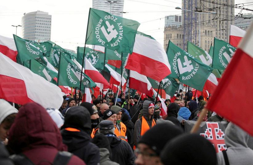  Protesters carry Polish flags and National Radical Camp flags during a rally, organised by far-right, nationalist groups, to mark 99th anniversary of Polish independence in Warsaw, Poland November 11, 2017.  (photo credit: AGENCJA GAZETA/ADAM STEPIEN VIA REUTERS)
