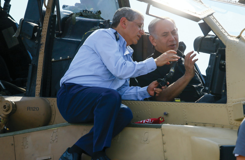  MAJ.-GEN.(RET.) AMIR ESHEL, then-air force commander-in-chief and current Defense Ministry director-general, with then-prime minister Benjamin Netanyahu inside an Apache helicopter during a visit to the Tel Nof base, in 2016. (credit: FLASH90)