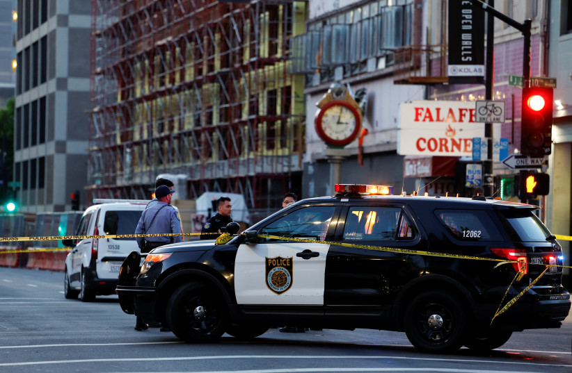  Police are seen after an early-morning shooting in a stretch of the downtown near the Golden 1 Center arena in Sacramento, California, U.S. April 3, 2022. (photo credit: REUTERS/FRED GREAVES)