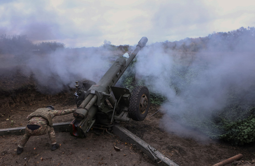 PREVIEW XML A member of the Ukrainian National Guard fires a D-30 howitzer towards Russian troops, amid Russia's attack on Ukraine, in Kharkiv region (photo credit: REUTERS)