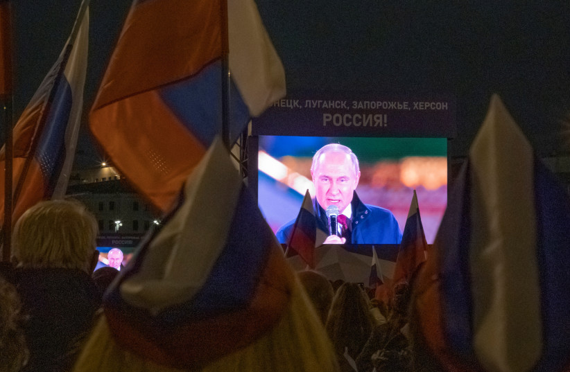  Russian President Vladimir Putin is seen on screens during a concert marking the declared annexation of the Russian-controlled territories of four Ukraine's Donetsk, Luhansk, Kherson and Zaporizhzhia regions, after holding what Russian authorities called referendums in the occupied areas of Ukraine (photo credit: VIA REUTERS)