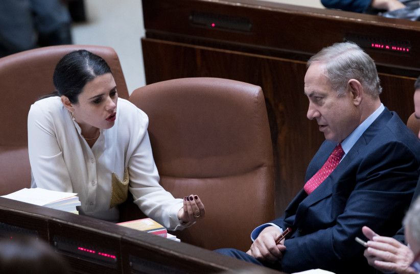  Prime Minister Benjamin Netanyahu speaks with then justice minister Ayelet Shaked (L) during a vote at the assembly hall of the Israeli parliament on December 21, 2016, during the state budget vote for 2017-2018.  (credit: YONATAN SINDEL/FLASH90)