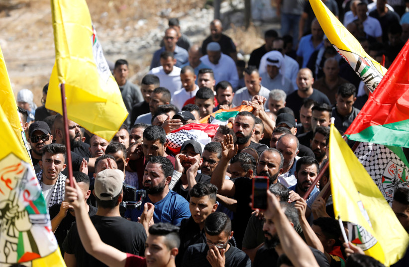  People mourn during the funeral of seven-year-old Palestinian boy Rayyan Suleiman (credit: MUSSA QAWASMA/REUTERS)