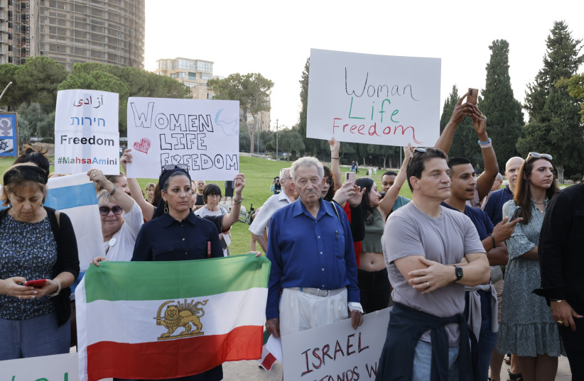  Demonstrators at Independence Park holding signs (credit: MARC ISRAEL SELLEM/THE JERUSALEM POST)