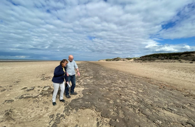  University of Manchester researchers assess the ancient footprints on Formby Point, UK.  (credit: THE UNIVERSITY OF MANCHESTER)