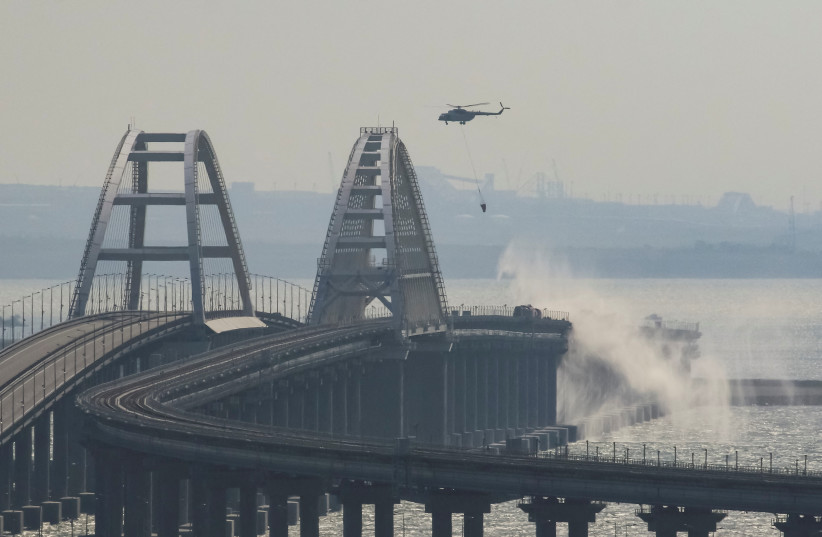  A helicopter drops water to extinguish fuel tanks ablaze on the Kerch bridge in the Kerch Strait, Crimea (credit: REUTERS)