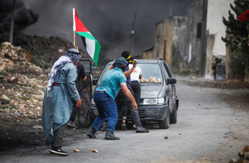  Palestinian demonstrators clash with Israeli security forces during a protest in the village of Kfar Qaddum, near the West Bank city of Nablus, October 7, 2022.  (credit: NASSER ISHTAYEH/FLASH90)