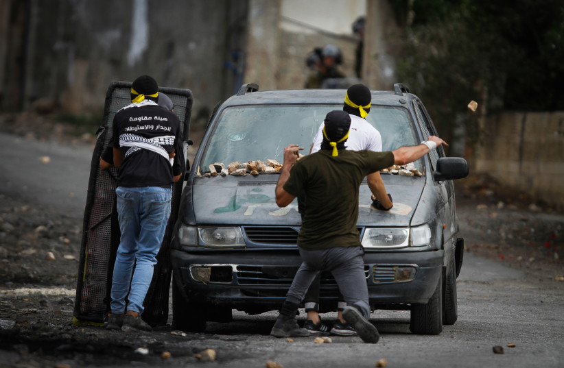 Palestinian demonstrators clash with Israeli security forces during a protest in the village of Kfar Qaddum, near the West Bank city of Nablus, October 7, 2022. (credit: NASSER ISHTAYEH/FLASH90)