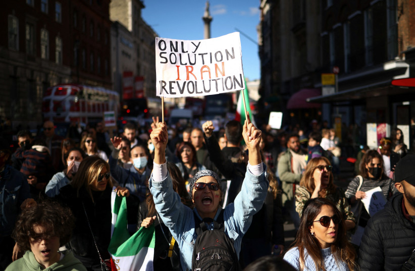 People demonstrate during a protest against the Islamic regime of Iran following the death of Mahsa Amini, in central London, Britain, October 8, 2022.  (credit: REUTERS/HENRY NICHOLLS)