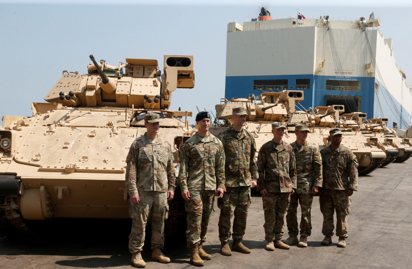 American soldiers stand near armored fighting vehicles contributed by the US government to the Lebanese army at Beirut's port, Lebanon, August 14, 2017. (credit: REUTERS/MOHAMED AZAKIR)