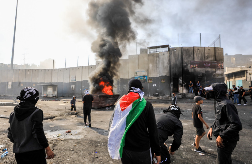  Palestinian youths clash with Israeli security forces in the Shuafat Refugee Camp, east Jerusalem, October 10, 2022.  (photo credit: JAMAL AWAD/FLASH90)