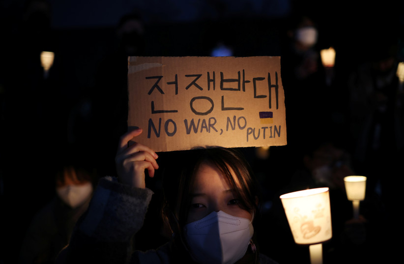  PREVIEW People attend a candle light vigil held in solidarity with Ukrainian people, as Russia's invasion in Ukraine continues, near Russian Embassy in Seoul, South Korea, March 4, 2022. (photo credit: REUTERS/KIM HONG-JI)