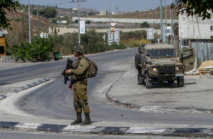  Israeli soldiers near the scene of a shooting, near the West Bank settlement of Shavei Shomron, on October 11, 2022.  (photo credit: NASSER ISHTAYEH/FLASH90)