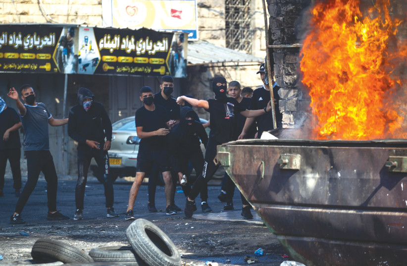  PALESTINIANS CLASH with Israeli security forces in the Shuafat Refugee Camp in Jerusalem, Monday.  (photo credit: JAMAL AWAD/FLASH90)
