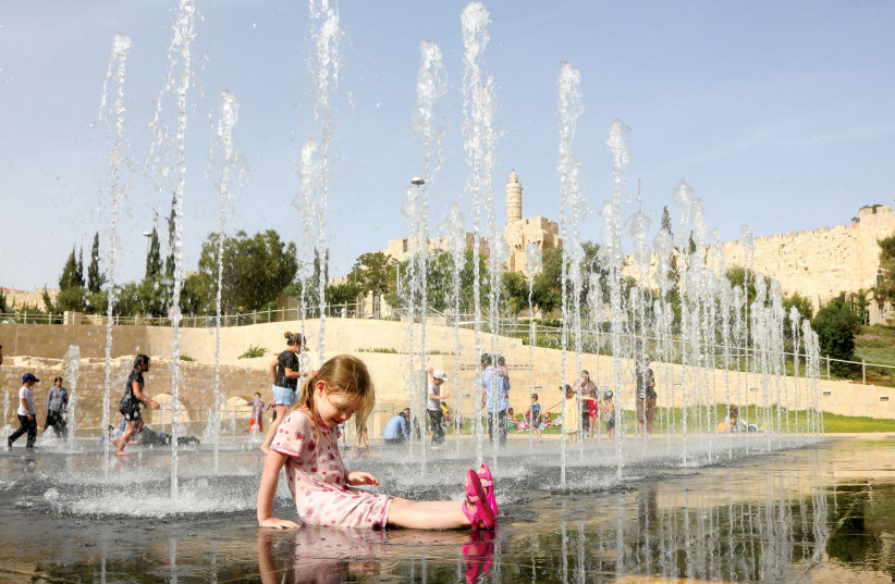  A girl cools off in the fountain of Teddy Park, developed by the Jerusalem Foundation in memory of the city’s long-serving mayor, Teddy Kollek. (photo credit: MARC ISRAEL SELLEM)