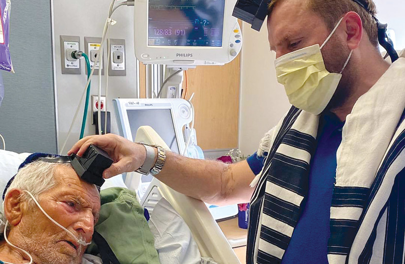  Rabbi Shmuley Boteach lays tefillin on his father in hospital. (photo credit: SHMULEY BOTEACH)